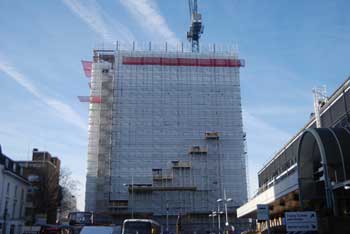 Sheeting encloses the tower as the new floors are erected