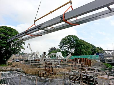 A walkway module is lifted into position