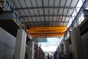 Large crane beams span the hall