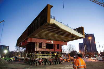 One of the Water Street bridges is transported to its final position